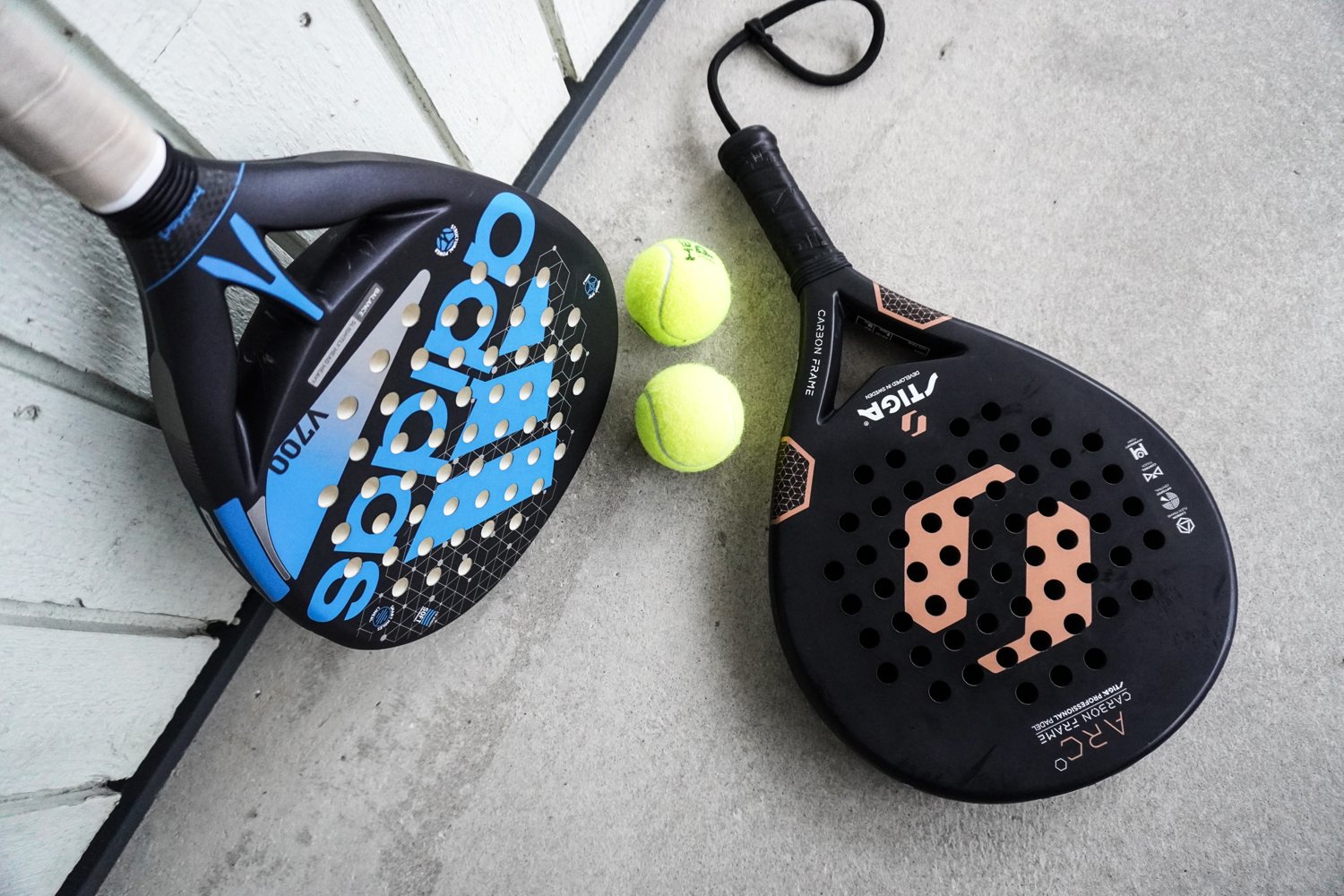 Padel rackets and yellow padel balls photographed together