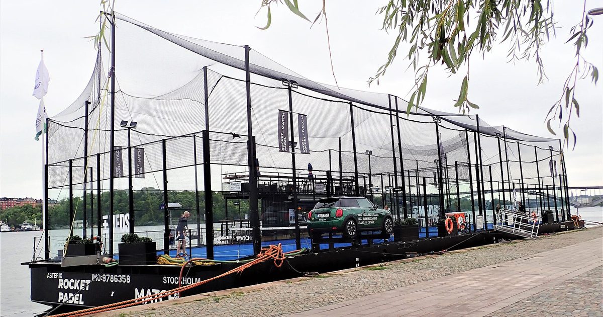 Four players moving on a padel court in Stockholm during a doubles match